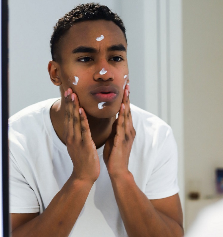 picture of a man putting a skincare product on his face