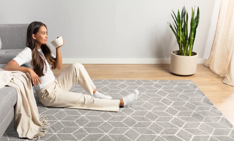girl sitting on a geometrical rug