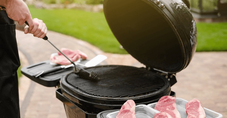 man cleaning and preparing the BBQ smoker