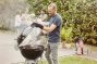 man making grill on the barbeque smoker for the family